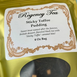 May include: A gold pouch with a white label that reads "Regency Tea Sticky Toffee Pudding". The label has a decorative border and text that says "Sweet treat named after the famous, British dessert: flavored black tea with 'Sticky Toffee' caramel bits! 4 Oz Bag".