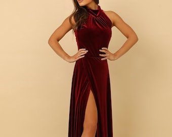 May include: A long, burgundy velvet dress with a high neck and a thigh-high slit. The dress has a fitted bodice and a flowing skirt.