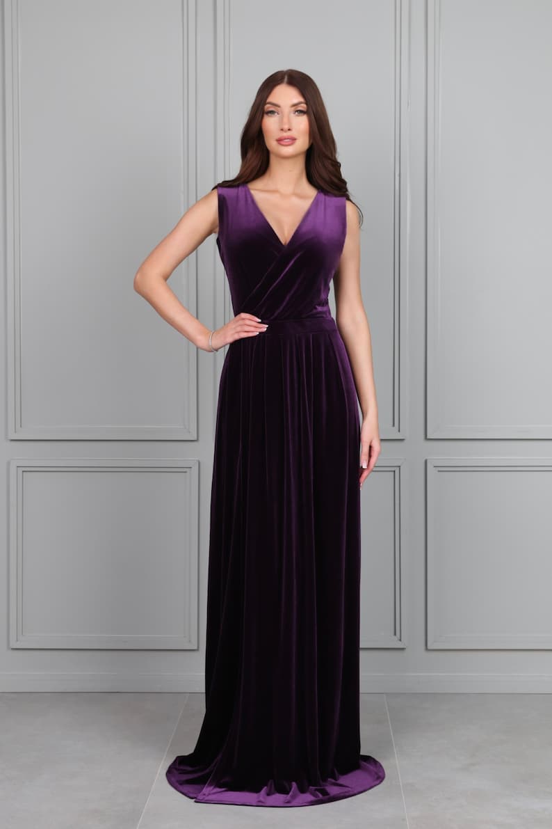 aubergine velvet sleeveless long dress.
A dress has a Wrap V- neck
 Closed back
 Sleeveless
 Waistband, waist sash
 High wrap leg slit
 Pleats
 Floor length