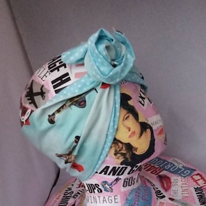 May include: A light blue turban with white polka dots and a vintage print featuring aeroplanes, lips, and the text "60s and Glamour".