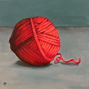 May include: A bright red ball of yarn with a long strand of yarn trailing off to the side. The yarn is on a light gray surface.