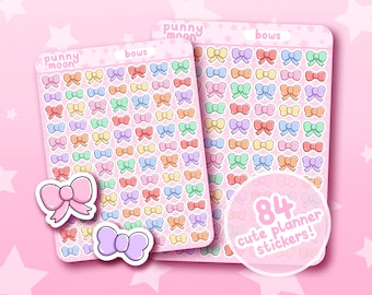 Può includere: Due fogli di adesivi per planner con 84 fiocchi carini in vari colori pastello. Il testo "punny moon" e "bows" è stampato sui fogli. Il testo "84 cute planner stickers!" è stampato su un adesivo circolare.