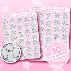 May include: A sheet of 30 cute planner stickers featuring a cartoon moon character with different facial expressions. The stickers are on a pink background and have the text "punny moon" and "Luna is stressed".