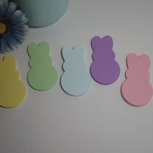 May include: Five pastel colored bunny shaped foam stickers. The colors are yellow, green, light blue, purple, and pink.