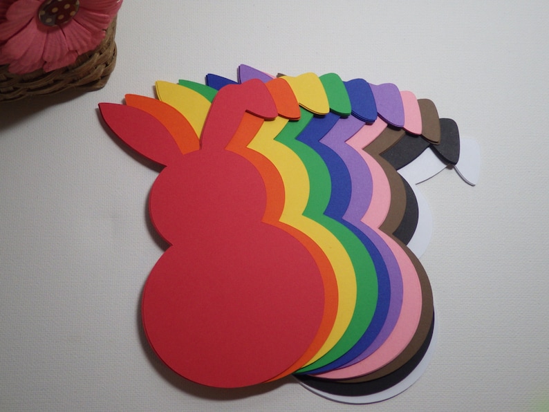 May include: A set of ten colorful foam bunny shapes in a rainbow pattern. The bunnies are arranged in a semi-circle with the red bunny at the front.