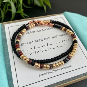 May include: Two beaded bracelets with black, gold, and red beads. The bracelets are in a box with a card that reads "Morse Code: Keep Him Safe Day and Night" and the Morse code for the message.  SunsetSouthpaw.etsy.com