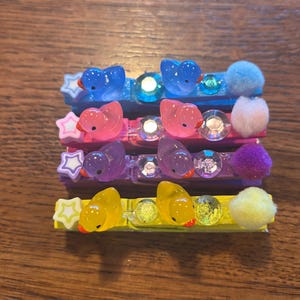 Volleyball clothes pin clips, cheer clips, dance clips with duck charms.