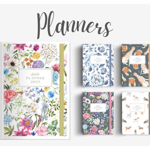 May include: Four different daily planners with floral and animal print designs. The planners are all the same size and have a gold or brown ribbon bookmark. The text on the planners reads "daily planner 2023".