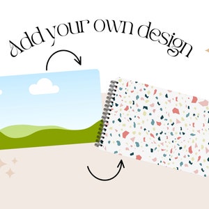 May include: Two spiral bound notebooks with different designs. One notebook has a blue sky with a white cloud and green hills. The other notebook has a white background with a terrazzo pattern in shades of pink, blue, green, and yellow. The text "Add your own design" is above the notebooks.