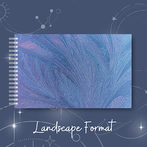 May include: A blue spiral bound notebook with a frosty, abstract design. The notebook is in landscape format.