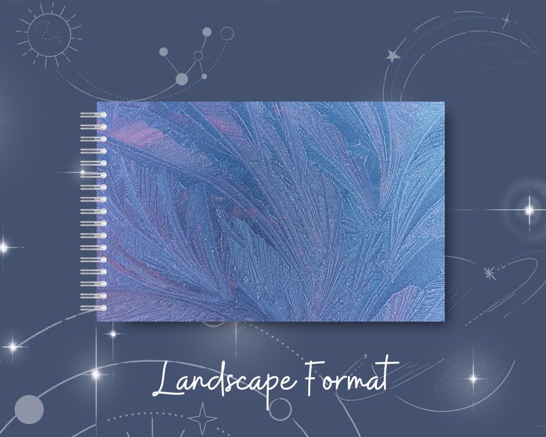 May include: A blue spiral bound notebook with a frosty, abstract design. The notebook is in landscape format.