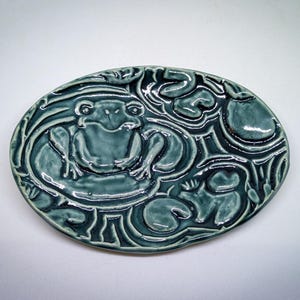 May include: A set of three ceramic mugs with a speckled, matte finish. The mugs are in shades of cream, light gray, and dark gray. Each mug has a simple, minimalist design, perfect for coffee or tea.