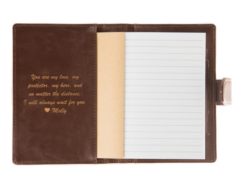 May include: Brown leather-bound journal with a gold inscription that reads "You are my love, my protector, my hero, and no matter the distance, I will always wait for you. Molly".