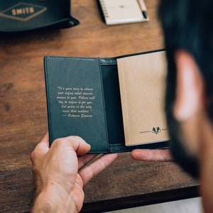 May include: A black leather notebook with a gold embossed quote by Octavia Spencer: "It's your turn to choose and define what success means to you. Others will try to define it for you, but yours is the only voice that matters."