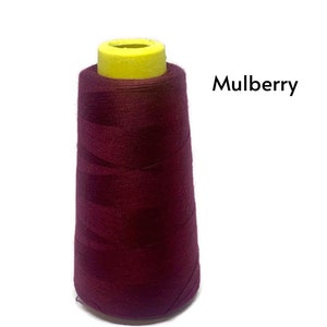 May include: A spool of maroon thread with a yellow plastic top. The text "Mulberry" is printed on a white background.