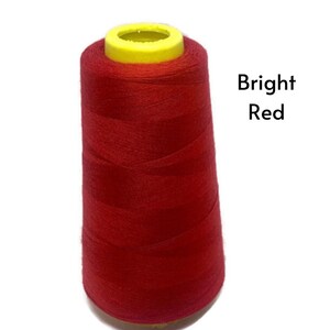 May include: A spool of bright red thread.