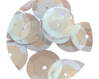 May include: A collection of circular, translucent, iridescent sequins. Each individual sequin features a smooth, reflective surface with a central hole for attachment, displaying a subtle rainbow sheen that shifts in color when light hits the surface.