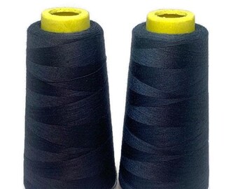 May include: Two spools of black thread with yellow plastic tops. The thread is wound tightly on the spools.
