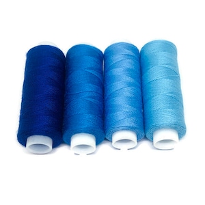 May include: Four spools of thread in shades of blue, from dark blue to light blue.