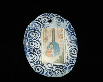 This is a handmade blue ceramic tile with a vintage Chinese card in the center.