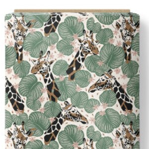 May include: A bolt of fabric featuring a repeating pattern of giraffe heads interspersed with large green tropical leaves and small light pink flowers on a cream-colored background. The giraffes have brown and black spots and white faces.