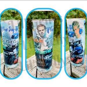 May include: A stainless steel tumbler with a collage of images and text. The tumbler features a photo of Paul Walker, a car, and the text "If one day they ask me do not cry because I was smiling".
