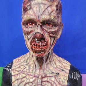The Walking Dead inspired walker bust signed by 2 actors.