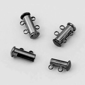 May include: Four black metal magnetic clasps for jewelry making. Each clasp has two loops on each end.