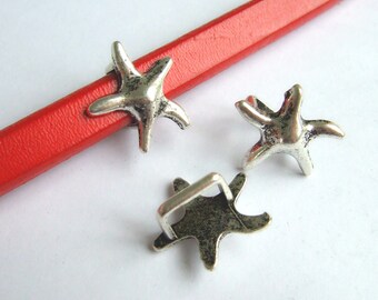 May include: Three silver-toned starfish charms with a textured finish. Two of the charms are flat and one has a loop on the back.