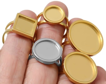 May include: A set of gold and silver rings with round and square bezels. The bezels are empty and ready to be filled with resin or other materials.
