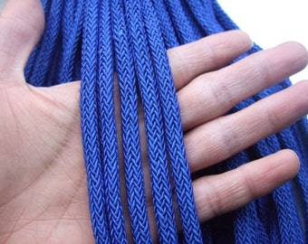 May include: A close-up of a bundle of blue braided cord. The cord is soft and flexible, and it is perfect for crafting projects.