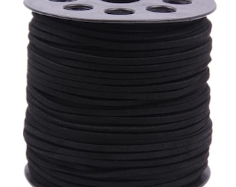 May include: A spool of black cord wrapped around a black plastic reel. The cord is thin, round, and matte in texture, wound tightly in multiple horizontal layers around the central cylinder of the spool, which features circular cutouts.