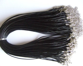 May include: A bulk pack of 50 black leather cords with silver lobster clasps. Each cord is approximately 18 inches long.