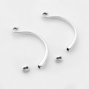 May include: Two silver-toned metal bracelet end caps with a hook on one end and a loop on the other. Two silver-toned metal jump rings are also included.
