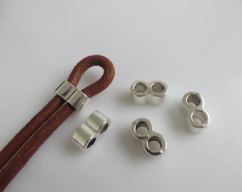 May include: Four silver metal cord ends with two holes each. The cord ends are designed to be used with leather cord.