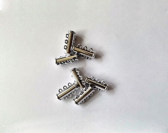 May include: Six silver-toned metal magnetic clasps for jewellery making. Each clasp has three loops for attaching multiple strands of beads or chains.