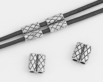 May include: Four silver metal cord ends with a diamond pattern. The cord ends are designed to be used with leather cord.