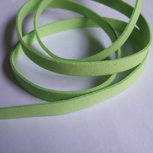 May include: A close-up of a light green leather cord, rolled up and ready for crafting projects.