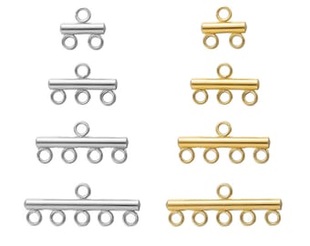 Op de afbeelding: Vier verschillende maten zilveren en gouden metalen connector-sluitingen voor het maken van sieraden. De sluitingen hebben een staaf met meerdere lussen om kettingen of koorden aan te bevestigen.