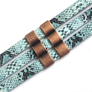 May include: A turquoise blue leather bracelet with a snakeskin pattern and three rows of metal accents. The metal accents are a dark bronze color and have a rectangular shape.