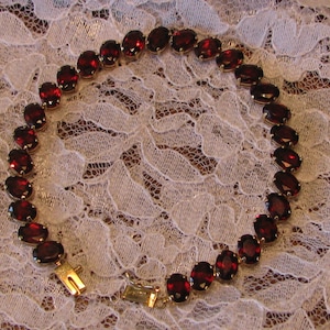 Stunning Mozambique Oval  Garnet Tennis Bracelet - 28 Cts. - 14K Yellow Gold  8 Grams