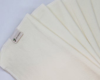May include: A set of six white cotton muslin cloths with a small brown label that says "Wild Roots".