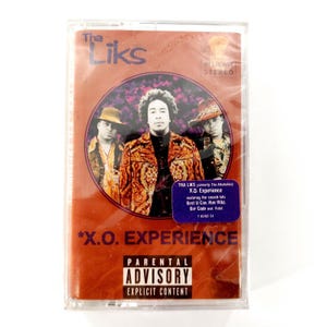 May include: A cassette tape for the album "X.O. Experience" by Tha Liks. The cover features three men in front of a brown background. The album title and parental advisory warning are also visible.