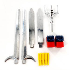 May include: A collection of vintage toy parts, including four silver swords, a silver and clear weapon, two red and blue blocks, and a cluster of yellow pegs. The items are arranged on a white surface.