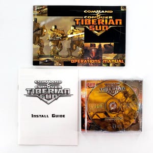 May include: A Command & Conquer: Tiberian Sun PC game set. Includes the game disc in a jewel case, an operations manual, and an install guide. The game's logo and title are prominently displayed on the packaging.