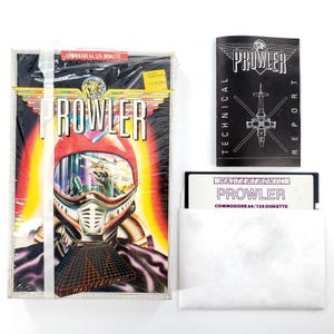 May include: A vintage Commodore 64/128 diskette game titled "Prowler." The game box features a futuristic helmet design with the game title in bold letters. Included are a technical report and a diskette in a white sleeve.