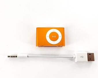 Reproductor MP3 Apple iPod Shuffle de segunda generación A1204 con clip dorado. Probado y en funcionamiento.