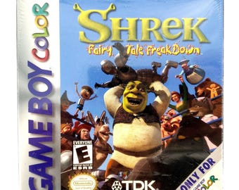 May include: Sealed Shrek: Fairy Tale Freakdown video game cartridge for Game Boy Color. The box features Shrek and other characters from the movie, with the game title in large yellow letters. The box is marked "Everyone" by the ESRB.