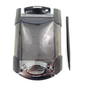 May include: A black Compaq iPAQ Pocket PC handheld device with a stylus. The device has a large screen, buttons, and the Compaq logo at the top. The stylus is black and slender. The device is on a white background.