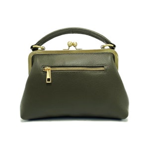 May include: A small, olive green leather handbag with a gold clasp and a zippered pocket on the back.